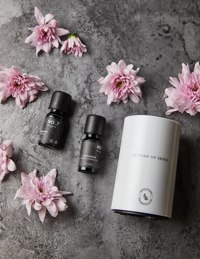 Portable ultrasonic diffuser set in Pink, White, or Black, includes AOS Essential Oil Blend for on-the-go aromatherapy.