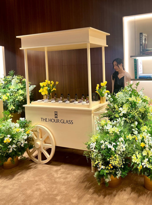 Bespoke luxury mobile fragrance cart with yellow botanical floral arrangements by Artisan of Sense for The Hour Glass VIP event in Singapore