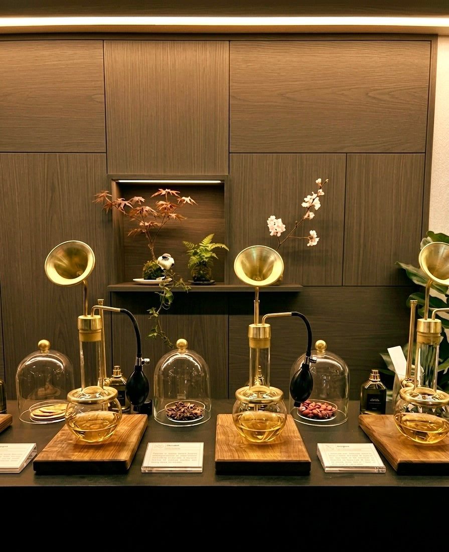 orporate Fragrance Bar Singapore featuring luxury brass olfactory diffusion apparatus and botanical fragrance oil display