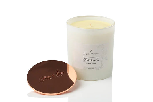 Patchouli, Orange & Clove soy candle with cotton wick, 70+ hour burn time, with sustainable packaging.
