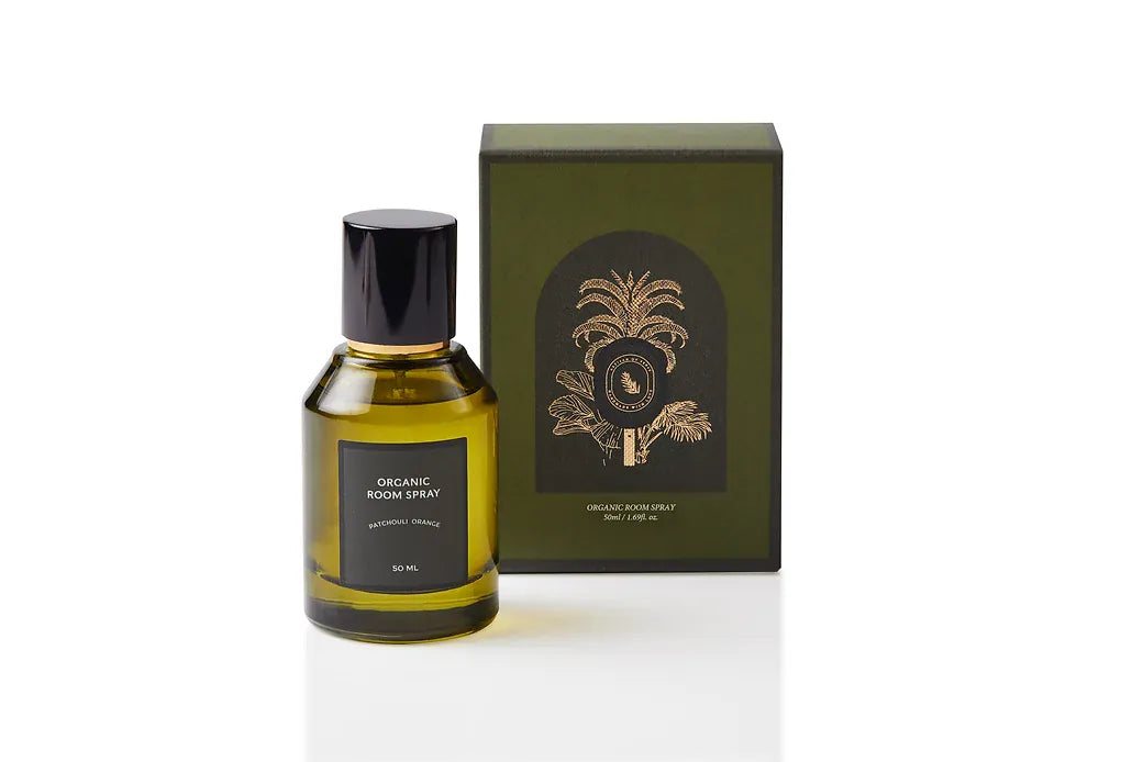 Patchouli and Orange botanical body and room mist, housed in luxury olive green glass with a black spray cap. Synthetic-free natural fragrance handcrafted in Singapore, pairing warm resinous depth with bright citrus for mindful daily rituals and calm, characterful rooms.